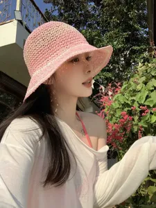Detailed view of the sweet pink straw bucket hat, perfect for spring vacation and sun protection.