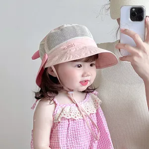 Pink baby sun hat detail showing breathable mesh crown, cute brim embroidery and chin strap.