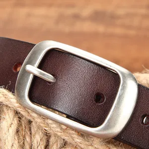 Echtleder Gürtel mit Metall Dornschnalle Nahaufnahme, klassisches braunes Design.
