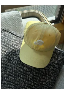 Yellow embroidered baseball cap featuring a curved brim, stylish summer sun protection hat.