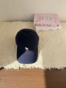 Detailgezicht van marineblauwe baseballpet met schattige witte hondenborduur, casual.