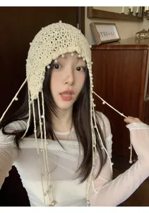 Handmade crochet pearl tassel beanie hat for women, spring summer hollow knit headwear detail.