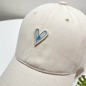 Beige heart embroidered baseball cap for women, stylish casual sun hat with soft top.