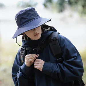 Outdoor sun protection bucket hat for men, wide brim fishing hiking cap with windproof strap.