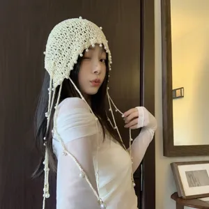 Handmade crochet pearl tassel beanie hat for women, hollow knit boho cap for spring and summer.