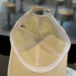 Minimalist baseball cap interior detail, adjustable strap and breathable lining design.