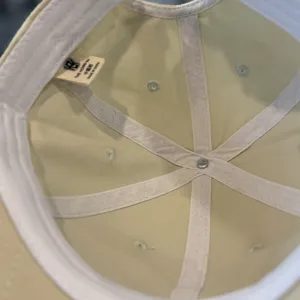 Baseball cap inner detail showing quality lining, neat stitching and breathable eyelets.