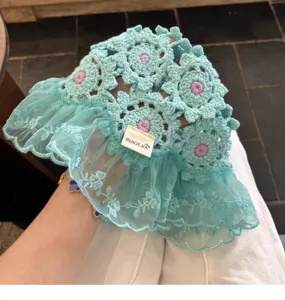 Detailed view of handmade crochet floral bucket hat with sweet lace brim, cute summer sun hat.