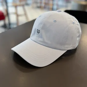 Close-up view of light blue baseball cap featuring cute cat embroidery and vents.