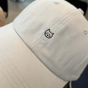 Minimalist light blue baseball cap with cute cat embroidery, perfect for casual outdoor wear.