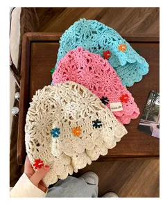 Handcrafted crochet flower detail and breathable texture of the summer sun bucket hat.