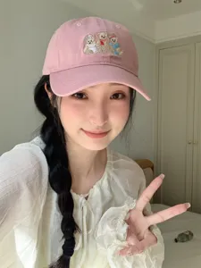 Pink baseball cap with cute bear embroidery, detailed lifestyle shot showing fabric and cute style.