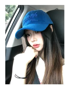 Retro blue baseball cap with letter embroidery for women, wide brim for sun protection.