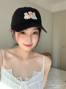 Close-up detail of the cute embroidered bear baseball cap, showing fine stitching.