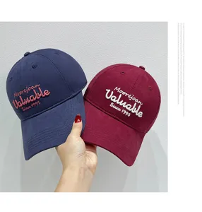 Detailed view of casual embroidered baseball caps featuring soft crown and stylish lettering.