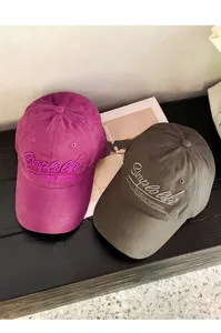 Detail view of stylish embroidered baseball cap, soft crown cotton hat with curved brim.