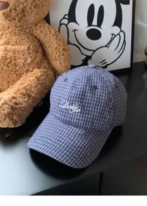 Korean style blue plaid baseball cap with delicate white embroidery detail, casual street style.