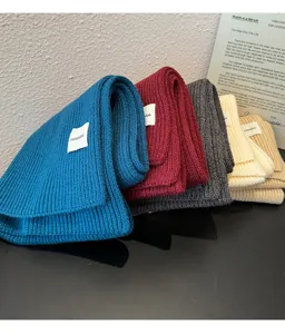 Cozy knitted winter scarf detail shot, soft ribbed texture, multiple chic colors for warmth