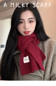 Detailed close-up of a thick warm knitted winter scarf in dark red, stylish accessory.
