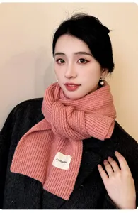 Close-up detail of cozy pink ribbed knit winter scarf, soft thick texture, stylish streetwear.
