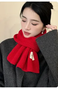 Close-up detail of a cozy red ribbed knit scarf, soft warm winter accessory for cold days.