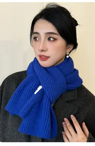 Close-up detail of a cozy blue knitted winter neck warmer scarf, soft and warm daily wear.