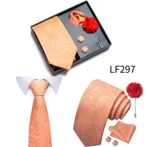 Close-up detail of the orange paisley jacquard men's tie set, showing fine fabric texture.