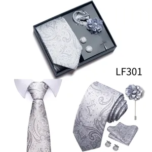 Men grey jacquard paisley tie pocket square cufflinks lapel flower set detail view.