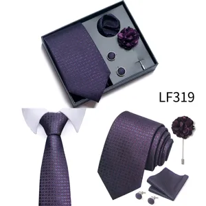 Close-up detail of luxury purple jacquard men's tie set, showing fine texture and accessories.