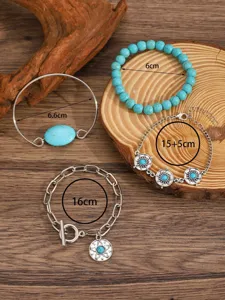 Turquoise bracelet set detail showcasing multiple bohemian styles, metal chains and stones.