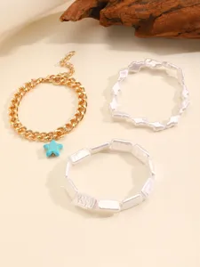Detail view of bohemian style bracelet set featuring star pendant and irregular white beads.