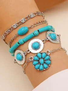 Bohemian multi-layer turquoise bracelet set featuring vintage silver chains and floral pendants.