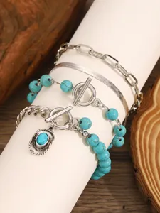 Detailed view of layered bohemian turquoise stone bead chain bracelets set with silver finish.