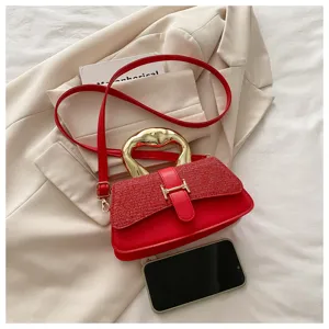 Red leather shoulder bag with unique golden handle and elegant flap design for women daily wear.