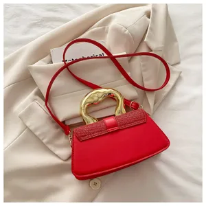 Chic red handbag with a stylish gold wavy handle and strap, perfect for modern women.