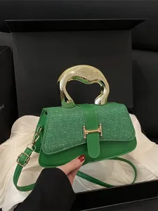 Green tweed shoulder crossbody bag with gold sculptural handle and elegant H-buckle design.