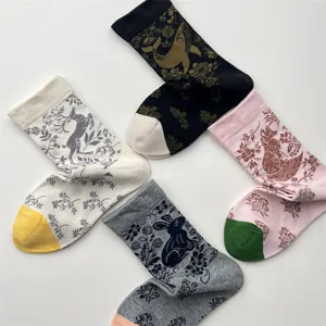 Cotton mid-tube socks featuring vintage animal and floral jacquard patterns in four colors.