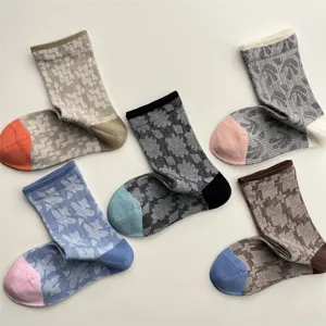 Detailed view of vintage geometric patterned crew socks with color block toes and heels for women.