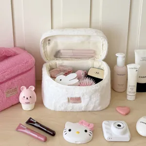 Detailed view of white fluffy cosmetic bag with interior mesh pocket, soft texture and portable design.