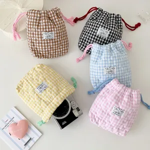 Korean style plaid cosmetic storage bag cute quilted fabric drawstring pouch for daily use.