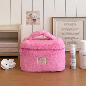 Pink plush cosmetic bag detail, soft fluffy travel makeup storage pouch with handle.