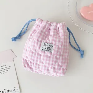 Korean plaid cosmetic pouch with cute cartoon label, quilted fabric drawstring bag detail.