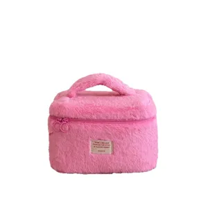 Pink fluffy makeup bag with top handle, cute plush cosmetic pouch for travel and daily storage.