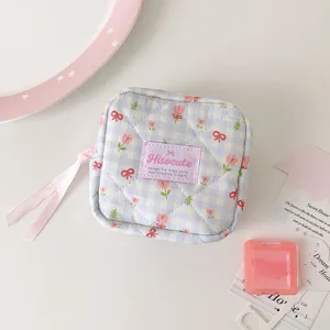 Cute quilted floral cosmetic pouch with sweet bow and ribbon zipper for daily tidy storage.