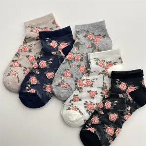 Detail view of breathable mesh short socks featuring charming pink rose floral patterns for women.
