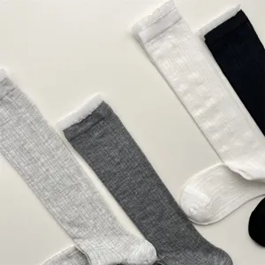 Detail view of breathable mesh calf socks with delicate lace trim, comfortable solid color design.