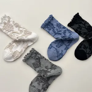 Close-up details of retro lettuce trim embossed floral mid-calf socks with soft cotton texture.