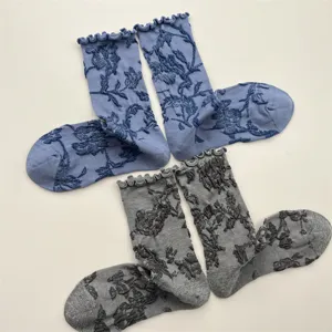 Detailed view of Japanese vintage floral embossed crew socks with cute ruffled cuffs.
