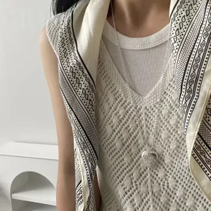 Details of the long beaded necklace with a hammered heart pendant for women, chic style.