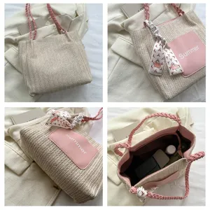 Close-up details of the woven straw tote bag featuring pink braided handles and front pocket.